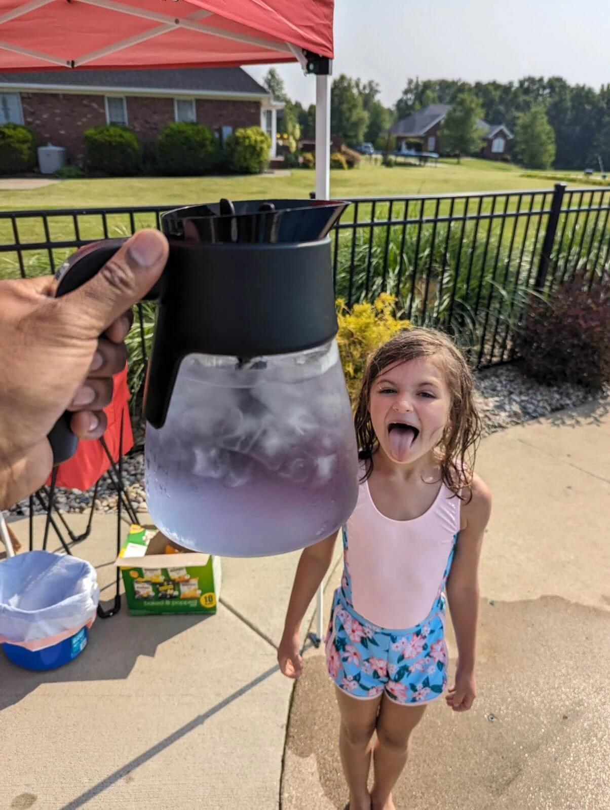 Child at pool party drinking tea