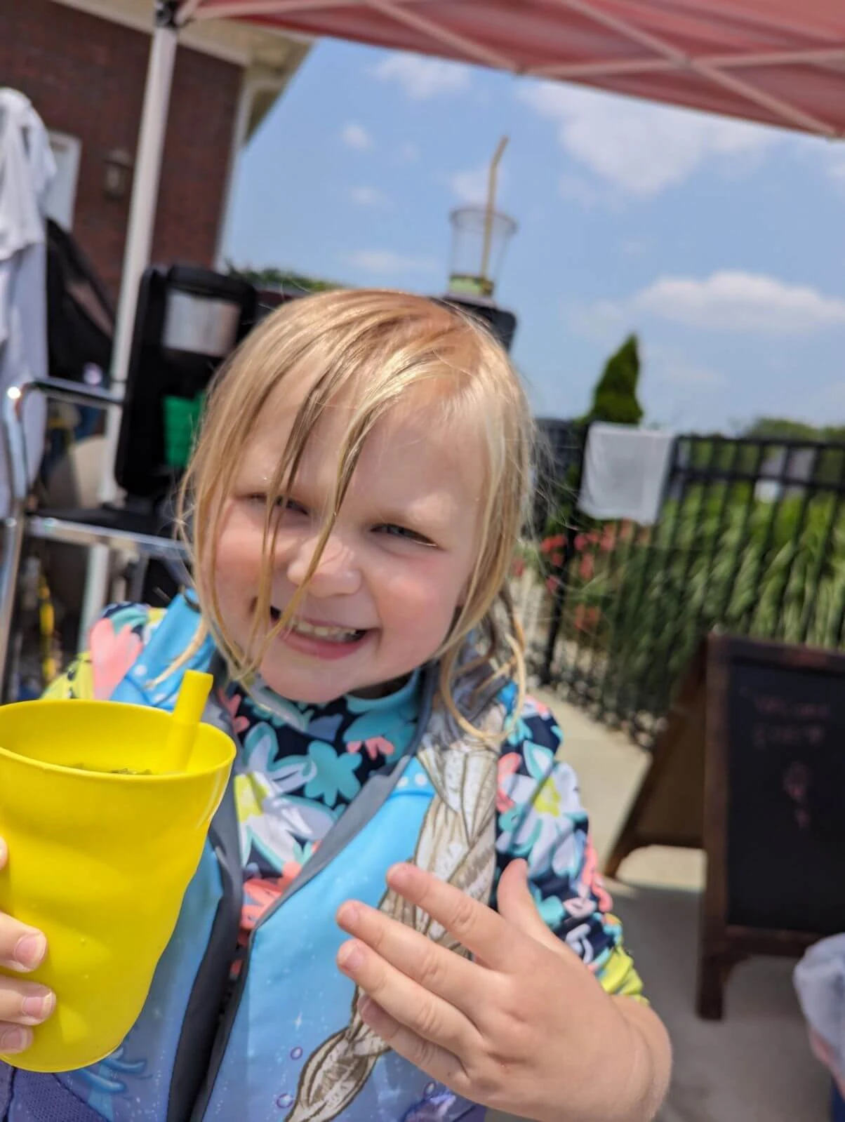 Child at pool party drinking tea