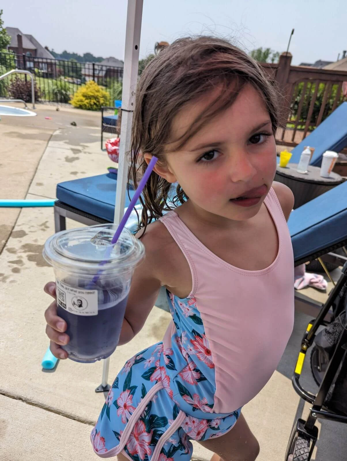 Child at pool party drinking tea